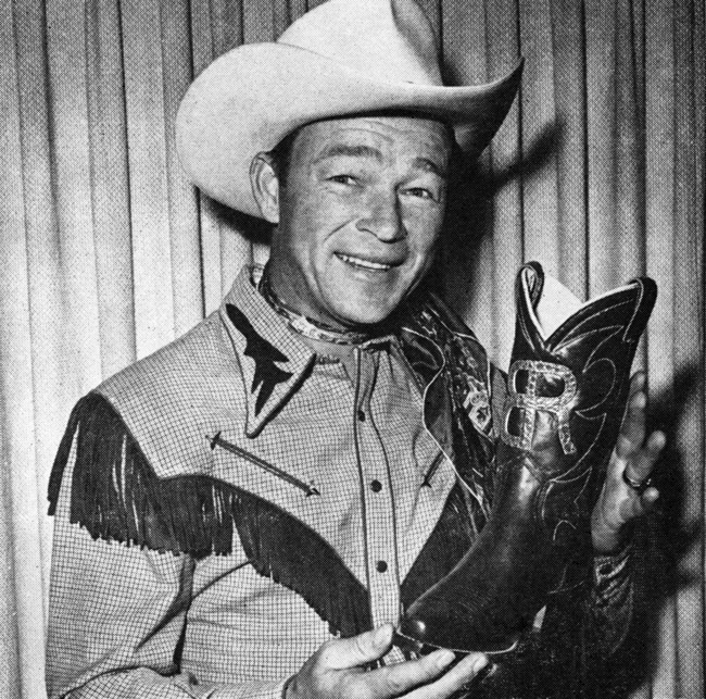 Picture of Roy Rogers with senior boots he gave to Boys Ranch seniors