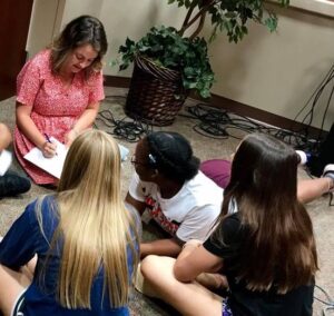 Woman teaching young girls scripture