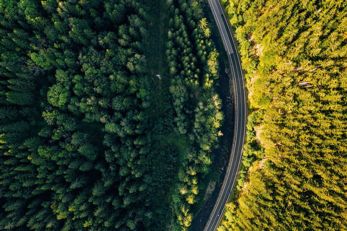 An aerial drone image shows a road below. Photo from Pixabay.