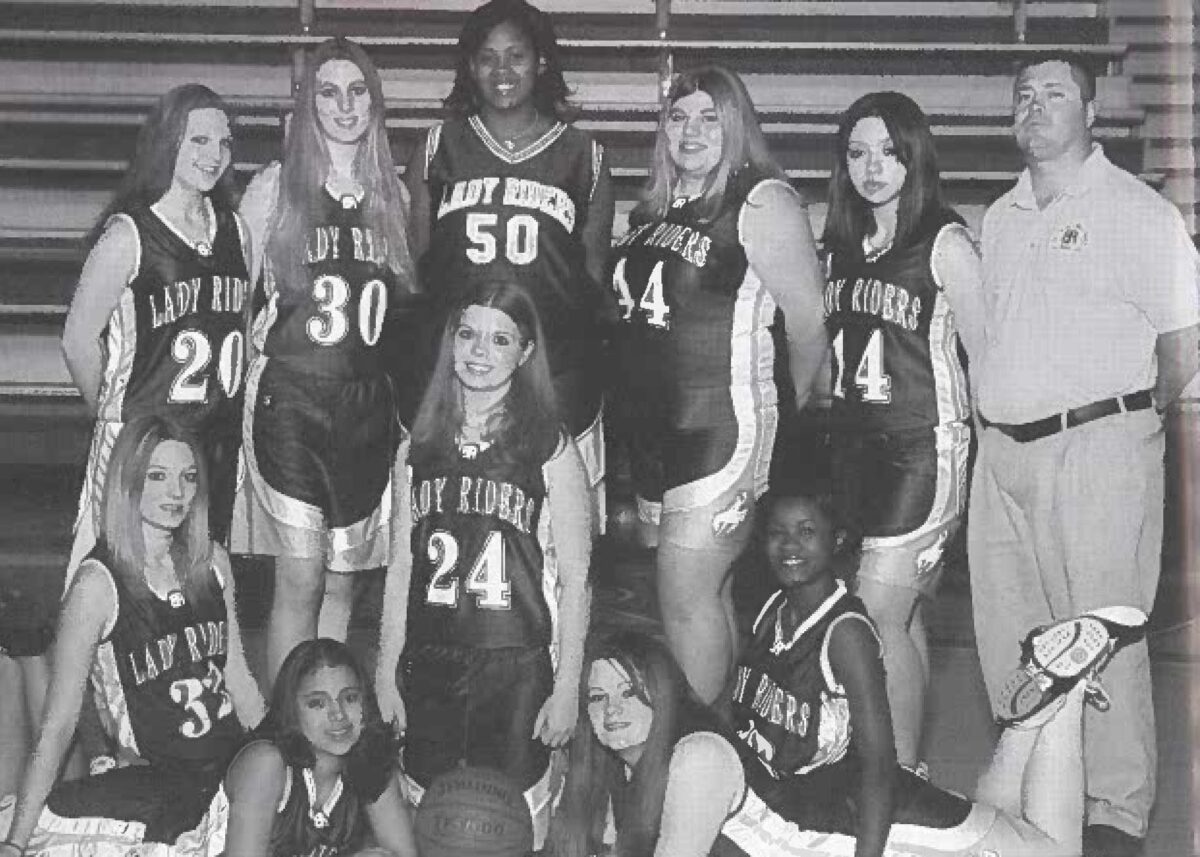 CeCe Bruce stands at the back of a group of basketball players.