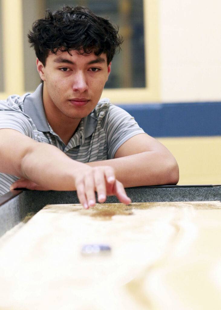 A boy plays a board game.