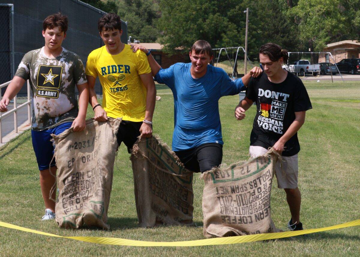 Four boys play sack race