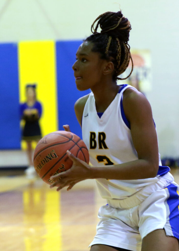 Braniya holds a basketball during a Roughriders game.