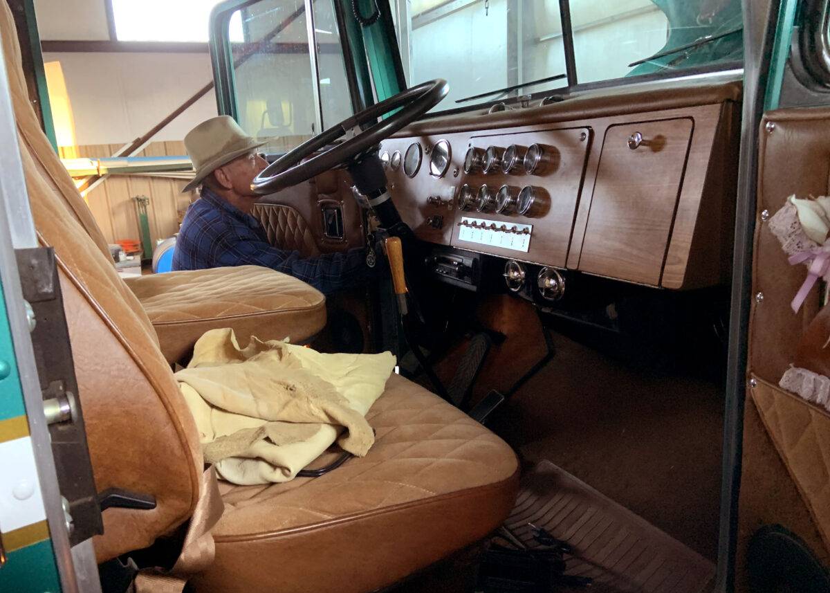 A man works on the interior of a vehicle.