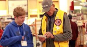 A man and a boy look at a shopping list together.