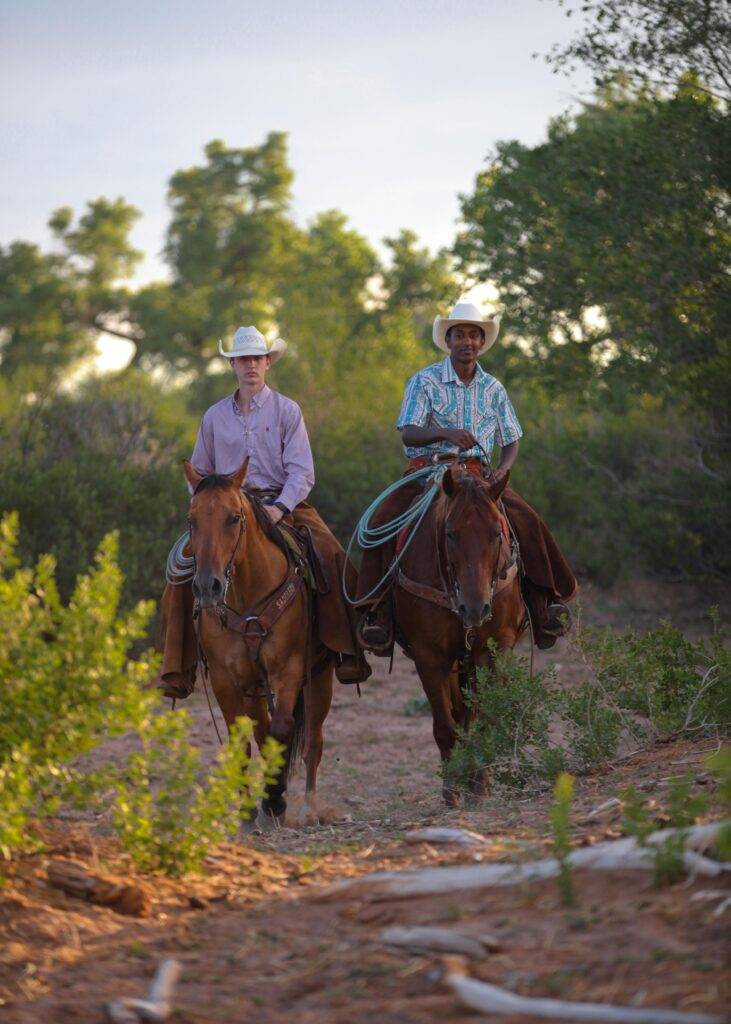 James and Nate ride through the brush.