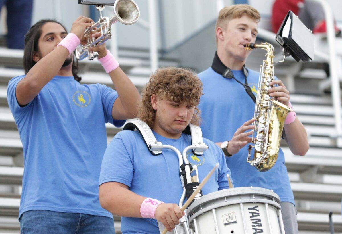 A trumpet, clarinet and drum are played in a pep band.