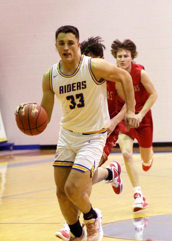 Grant drives to the basket for the Roughriders.