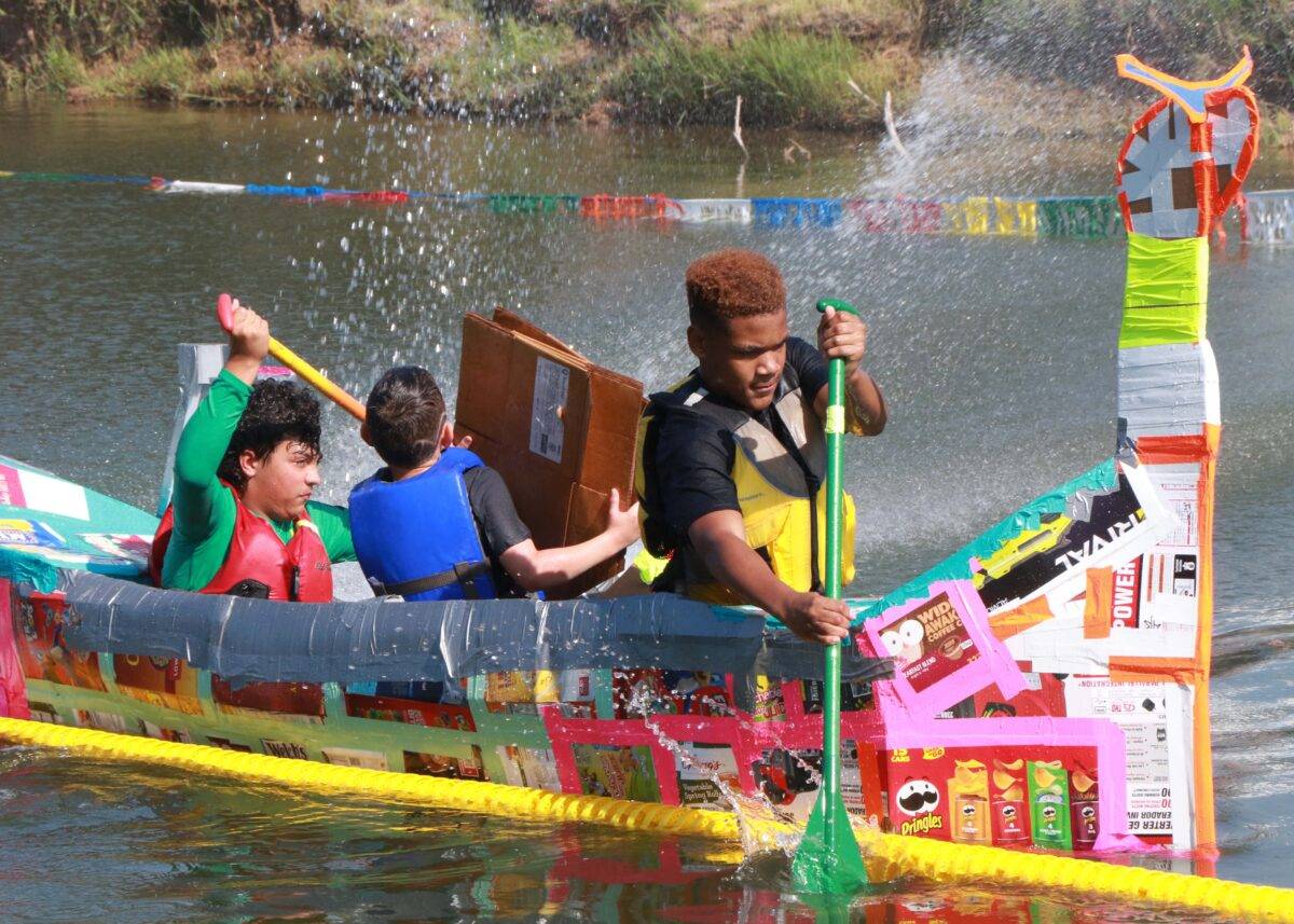 Nathan rows a Cardboard Boat with his teammates.