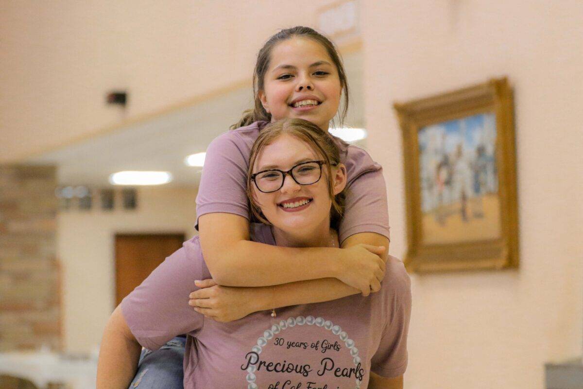 Sarah gives Nevaeh a piggyback ride.