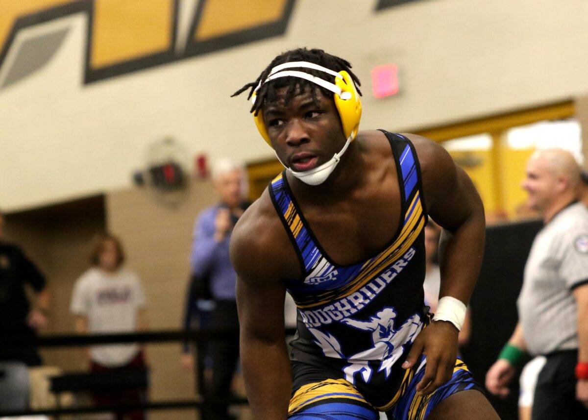 Jaay prepares to wrestle while wearing a Boys Ranch High School uniform.